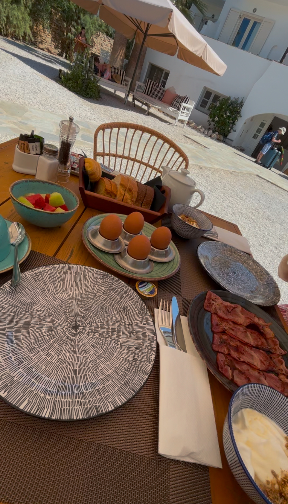 Breakfast under the Greek sun, with Daisy welcome at the table.
